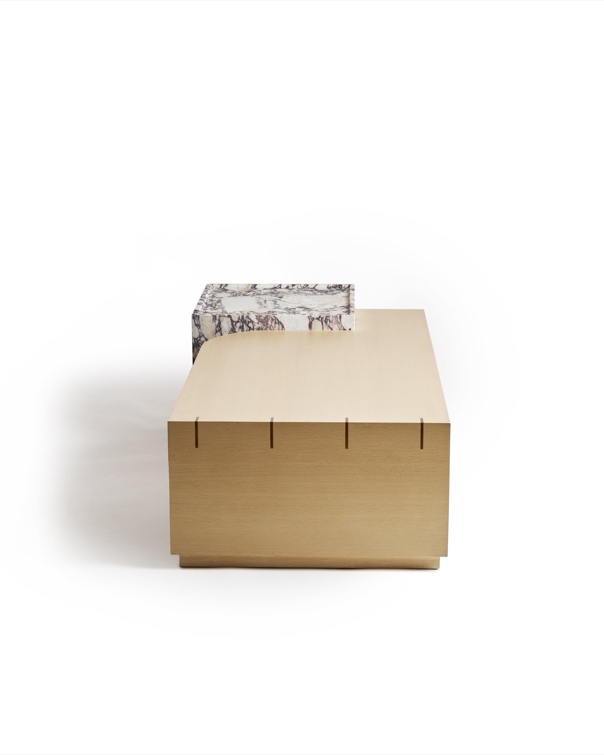 Sculptural custom coffee table with natural veneer, Calacatta Viola marble, and brass accents.